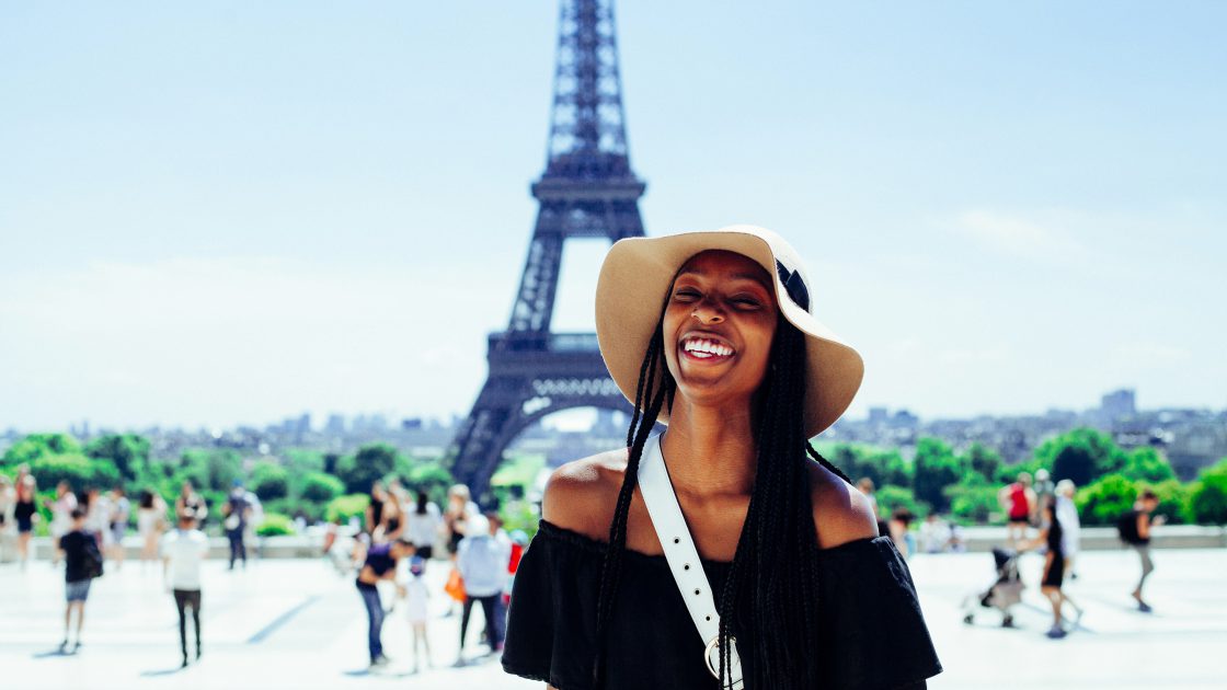 Woman smiling in front of eiffel tower